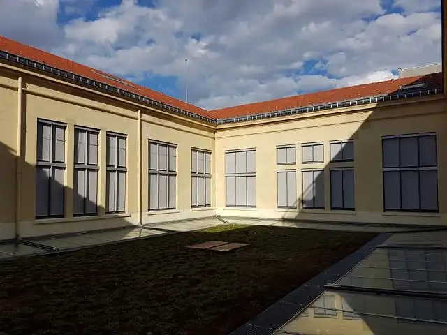 Cour des Archives municipales : stores extérieurs gris baissés sur deux façades